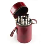 Property of a lady - a modern red leather cased set of three glass spirit flasks, the case 7.