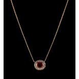 A yellow gold ruby & diamond necklace, the cushion cut ruby weighing 1.08 carats, set within a