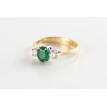 Property of a lady - an 18ct yellow gold emerald & diamond three stone ring, the estimated total