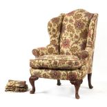 Property of a gentleman - a George I / II style floral upholstered wing armchair with carved
