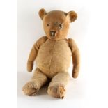 Property of a gentleman - an antique & well-loved teddy bear, straw filled, 22.5ins. (57cms.)