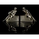 Property of a gentleman - a pair of Art Deco filled metal figural bookends, each with roundel