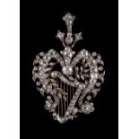 A fine Victorian diamond harp brooch, with stylised ribbon & floral border, the estimated total