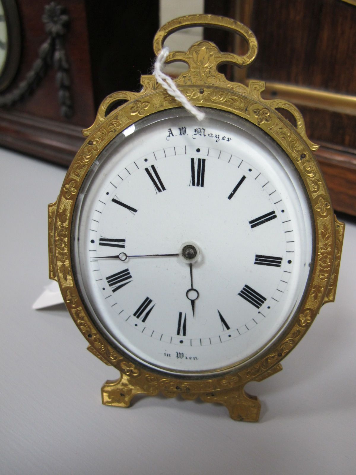 A. W. Mayer in Wien Oval Enamel Dial Table Clock, with gilt metal frame having easel back.