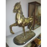 A Large Brass Prancing Horse, on oval stepped platform and marble base, 62cm high overall.