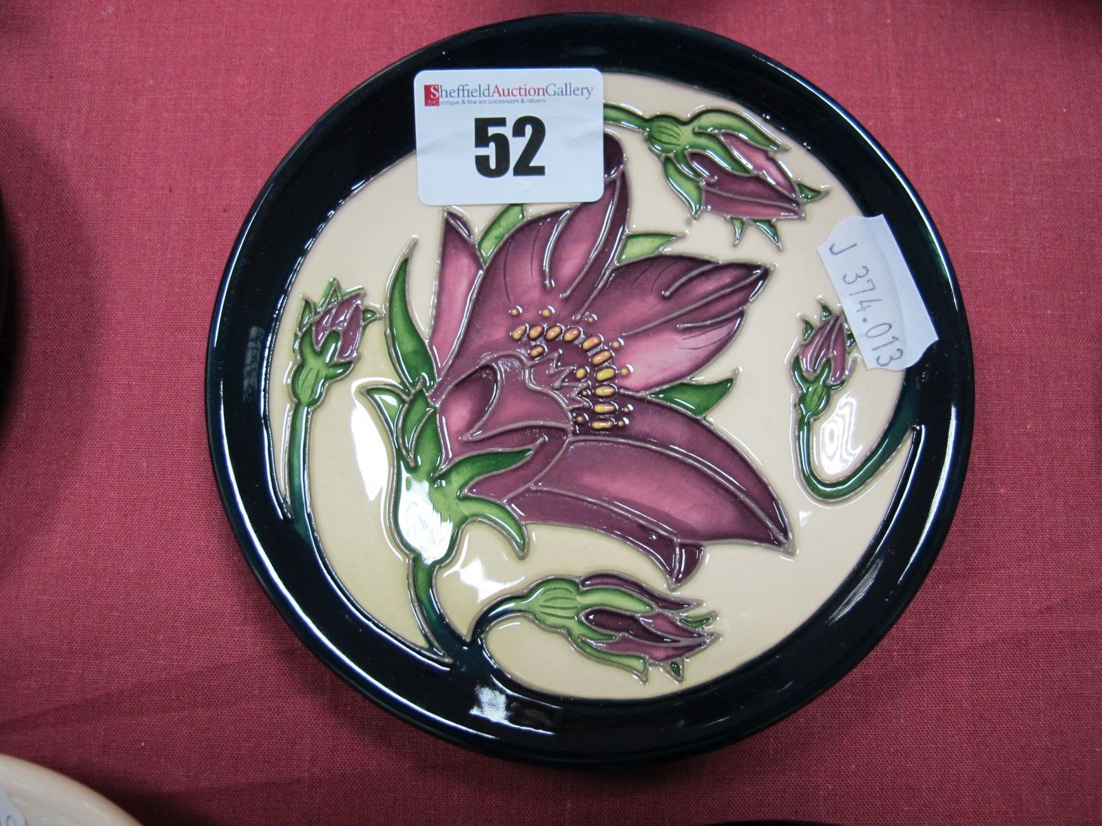 A Moorcroft Pottery Coaster, decorated with the 'Pulsatilla' design by Vicky Lovatt, shape 780/4,