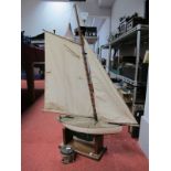 A Scratch Built Wooden Model Yacht, fabric sails, green painted lower body, on plinth stand, overall