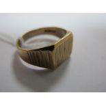 A 9ct Gold Gent's Ring, of bark textured finish with square panel between tapering shoulders.