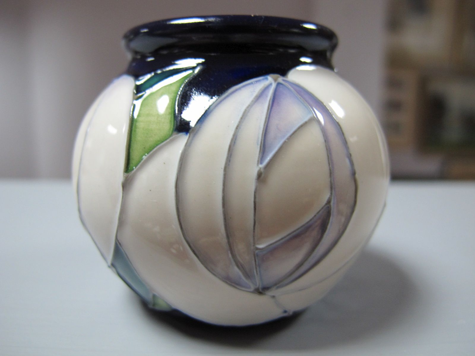 A Moorcroft Pottery Spherical Vase, decorated with the 'White Rose' design by Emma Bossons, shape