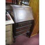 An Early XX Century Mahogany Bureau, with a fall front, fitted interior, three long drawers on