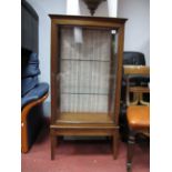 An Edwardian Mahogany Display Cabinet, with a cross banded top, with a glazed door and sides, on