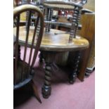 A 1920's Oak Oval Topped Dining Table, with wind-out action, on barley twist legs, and one spare