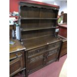 An Oak Dresser, shaped cornice over two plate racks, all above two small frieze drawer with