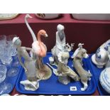 A Lladro Model Dog, base impressed 10, a Nao seated clown, slender goose, Lladro lady with geese,