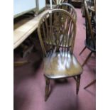 A Set of Eight Wheelback Windsor Dining Chairs, on ring turned 'H' stretchered legs. (8)