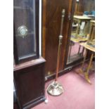 An Early XX Century Brass Telescopic Standard Lamp, on a circular base with bun feet.