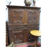 A Spanish Style Cabinet, with four doors, twin drawers, and blind fretwork side panels.