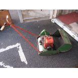 A Petrol Driven Lawn Mower and Grass Basket.