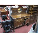 A 1920's Oak Sideboard, with circular bevelled mirror to low back, on barley twist legs.