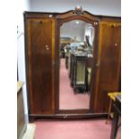 A 1920's Mahogany Wardrobe, with a shaped top, central mirror flanking door, with satinwood cross