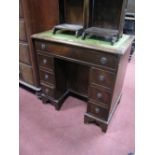 A Mahogany Ladies Kneehole Desk, with inset leather scriver, seven drawers and recessed cupboard