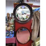 A Circular Bevelled Wall Mirror, in tortoiseshell effect frame; together with an oval wall