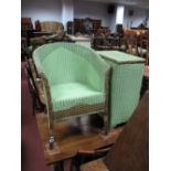 A Lloyd Loom Tub Chair, in green (with applied manufacturers label) and a Lloyd Loom linen