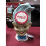 A Coca Cola Advertising Money Box,as a Happy Boy, in painted metal, 19cm high.