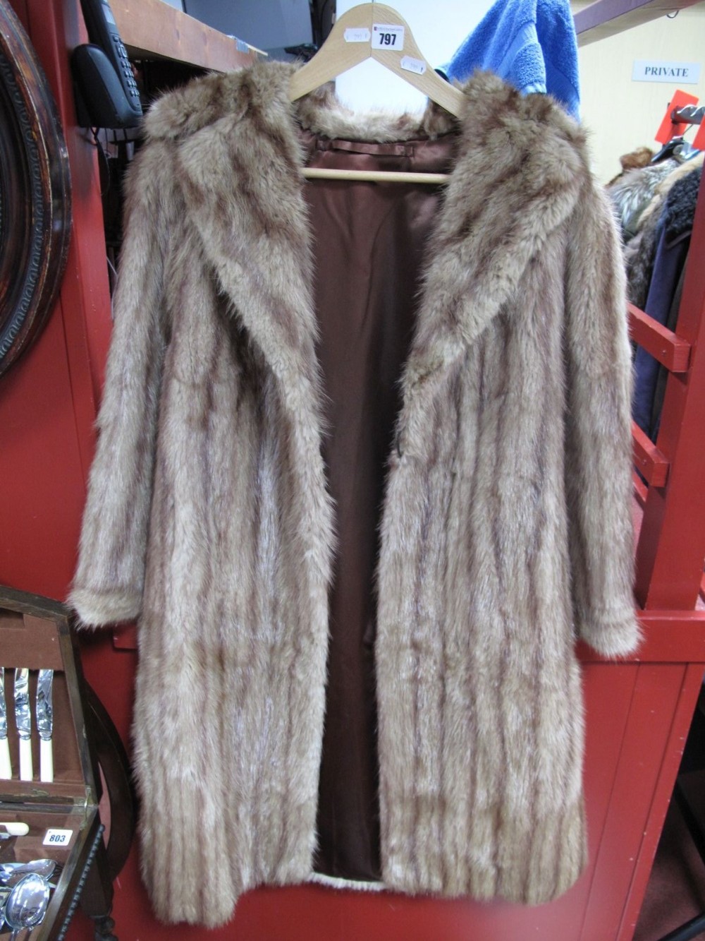 A Ladies Light Brown Knee Length Fur Coat.