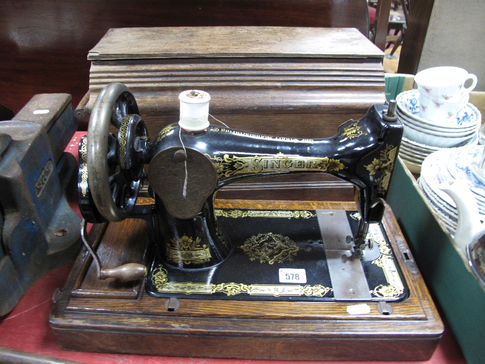 A Late XIX Century Singer Sewing Machine, in an oak case.