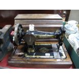 A Late XIX Century Singer Sewing Machine, in an oak case.