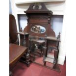 An Edwardian Walnut Over mantle, having oval and rectangular bevelled mirrors and spindle supports