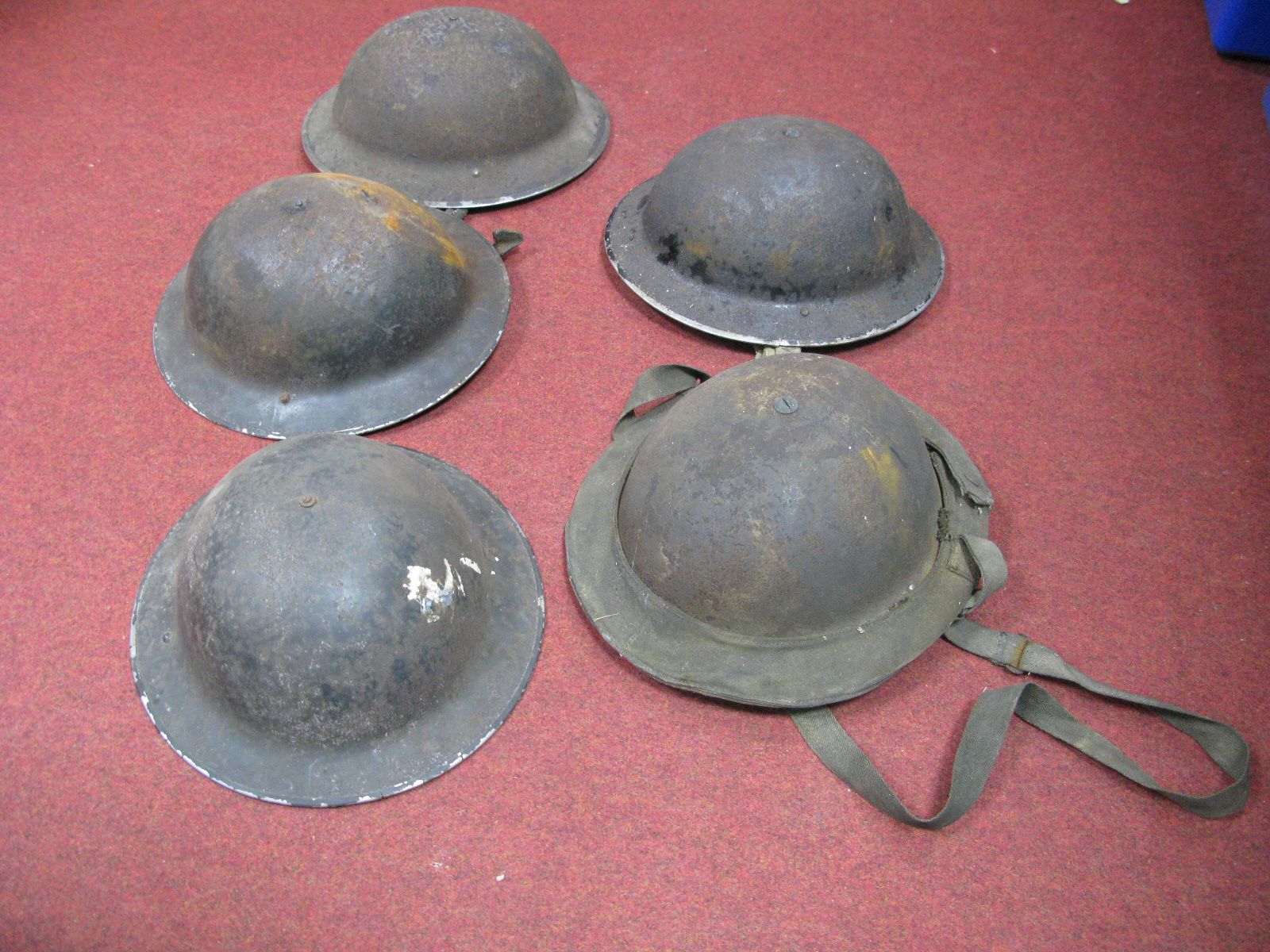 Five WWII Era Steel Civilian helmets, one in canvas bag.