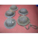 Five WWII Era Steel Civilian helmets, one in canvas bag.