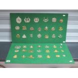 A Collection of Forty One Mainly Military Cap Badges, mounted on two boards. The Kings Own,