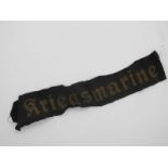 A 'Kriegsmarine' Cuff Title, gold on black.