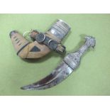 An Early to Mid XX Century Arab Dagger, in scabbard, with white metal fittings, blade badly rusted.