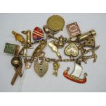 A Charm Bracelet, to 9ct gold heart shape padlock clasp, suspending numerous novelty charm