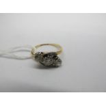 A Three Stone Diamond Ring, of crossover design, claw set with graduated brilliant cut stones,