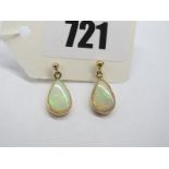 A Pair of Modern 9ct Gold Opal Set Earrings, pear shape collet set.