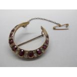 A Ruby and Diamond Set Crescent Brooch, alternately graduated set.