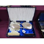 A Matched Hallmarked Silver Four Piece Dressing Table Set, Birmingham 1984, 1985, each with engine