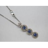 A 9ct White Gold Sapphire and Diamond Set Triple Cluster Drop Pendant, composed of three uniform