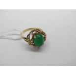 A Single Stone Ring, oval cabochon claw set to the centre within scroll border, indistinctly