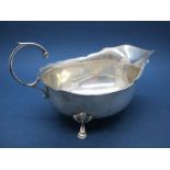 A Hallmarked Silver Sauce Boat, ESB, Birmingham 1911, with wavy cut edge and flying scroll handle,