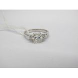 An 18ct White Gold Three Stone Diamond Ring, the central (7x5.5mm) radiant cut stone four claw set