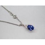 A Modern 18ct White Gold Tanzanite and Diamond Set Pendant, graduated claw set throughout on split