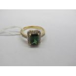 An 18ct Gold Green Tourmaline and Diamond Cluster Ring, rectangular set to the centre, within border