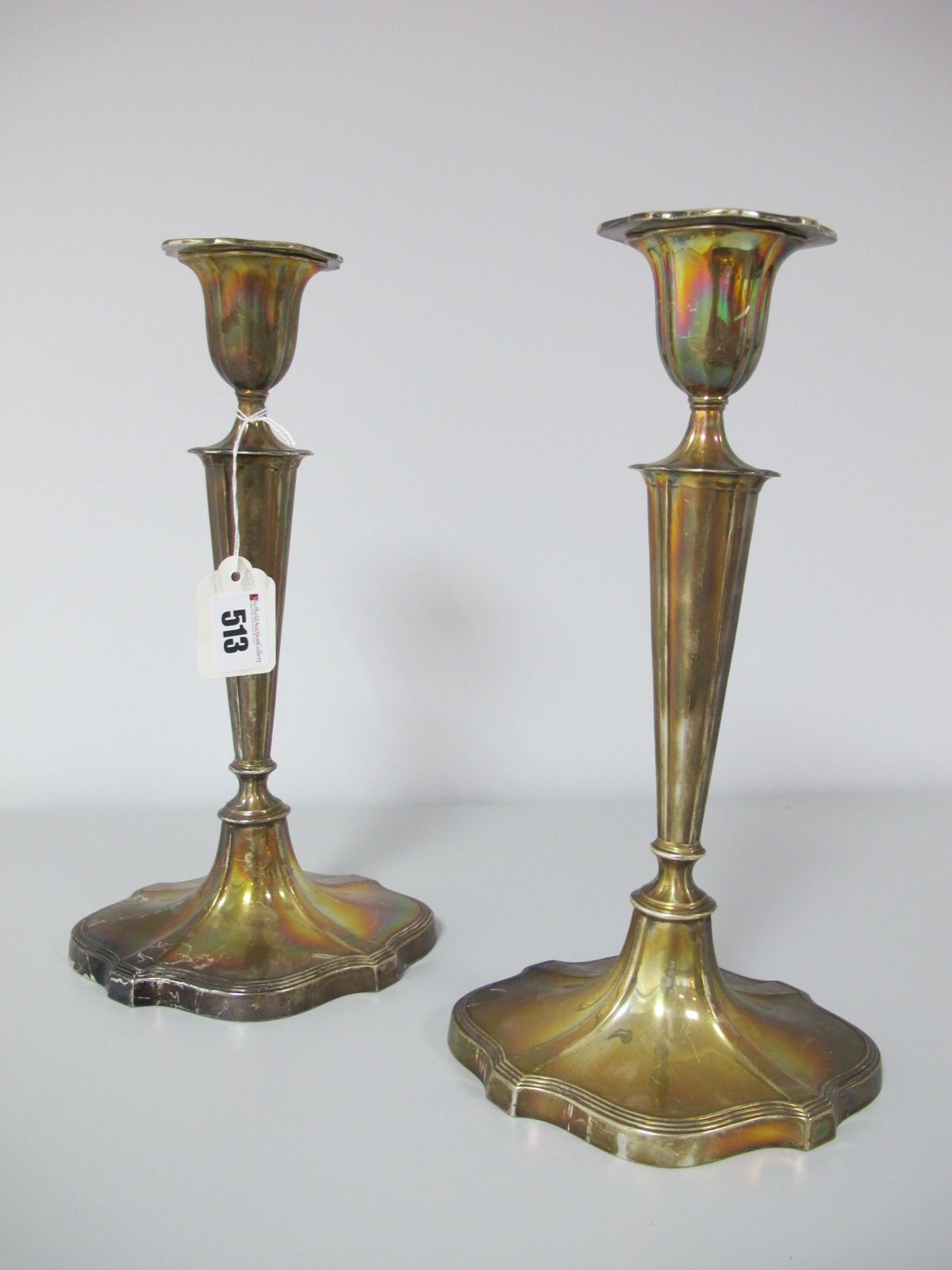 A Pair of Hallmarked Silver Candlesticks, Walker & Hall, Sheffield 1914, each with tapering stem,