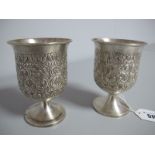 A Pair of Goblets, each detailed in relief with foliate leaf scrolls, on plain circular spreading